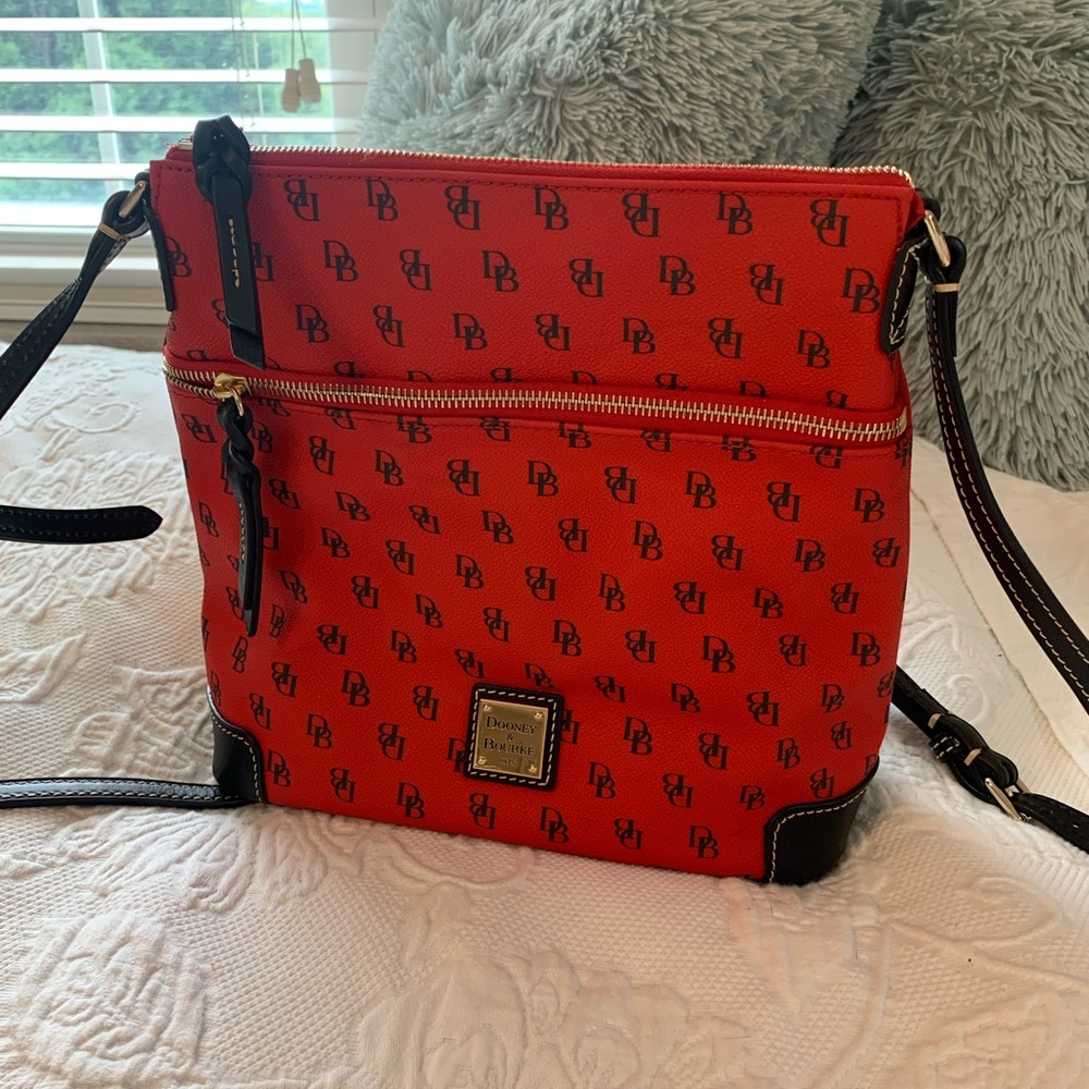 Reddish orange or orangish red Dooney and Bourke bag.